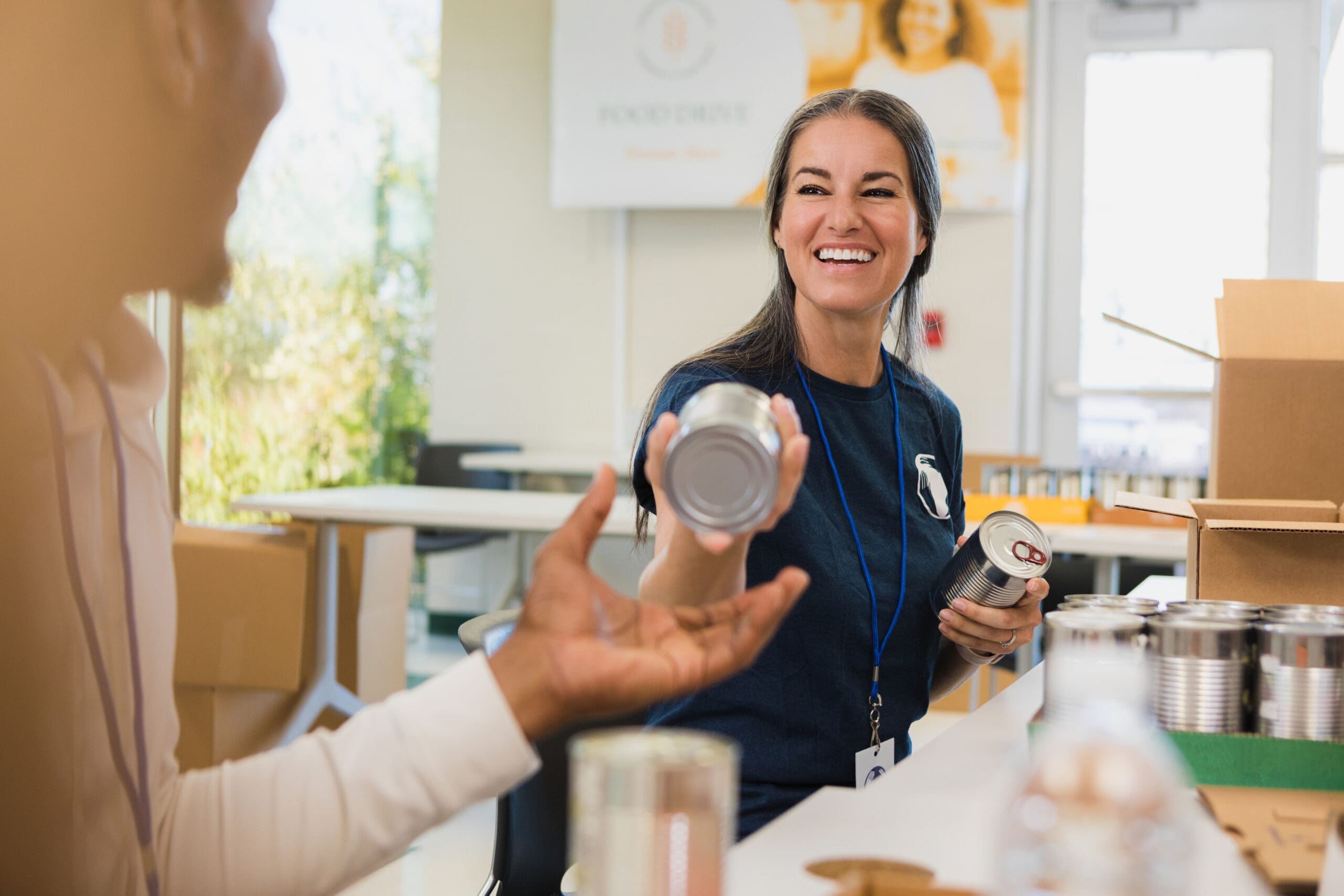 “United Way volunteers organizing canned food donations for local partner pantries in central Oklahoma.